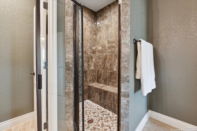 bathroom featuring a shower with shower door