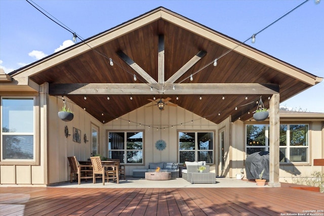 wooden terrace with outdoor lounge area and ceiling fan