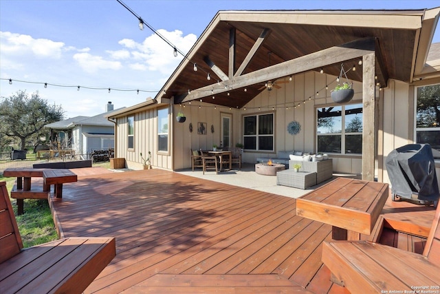 wooden deck with ceiling fan, outdoor lounge area, and area for grilling