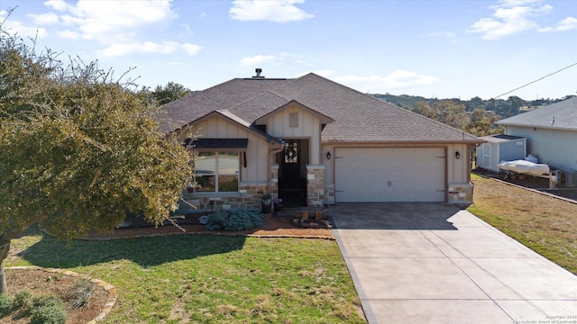 view of front of property with a garage and a front lawn