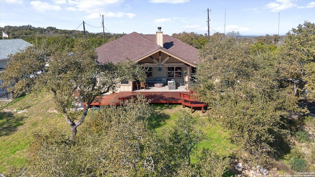 rear view of property with outdoor lounge area and a deck