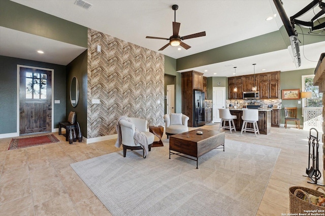 living room with a wealth of natural light and ceiling fan