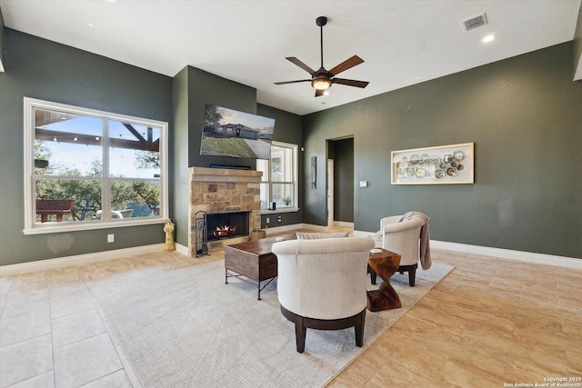 living room with lofted ceiling, light tile patterned floors, a fireplace, and ceiling fan