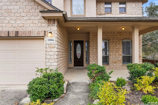 view of exterior entry with a garage