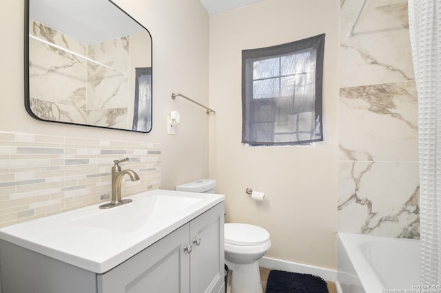 full bathroom with vanity, backsplash, tiled shower / bath combo, and toilet