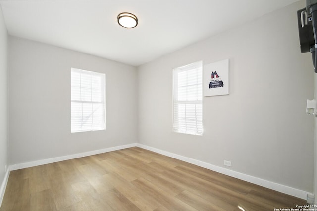 spare room with hardwood / wood-style floors