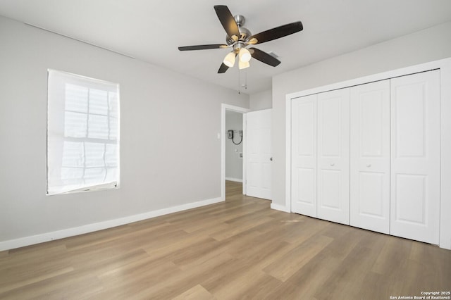 unfurnished bedroom with ceiling fan, light hardwood / wood-style floors, and a closet