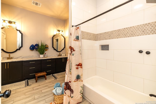 bathroom featuring vanity and shower / tub combo with curtain