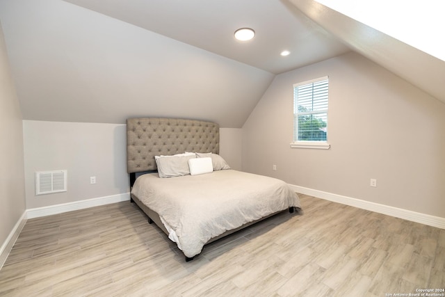 bedroom featuring vaulted ceiling and light hardwood / wood-style floors