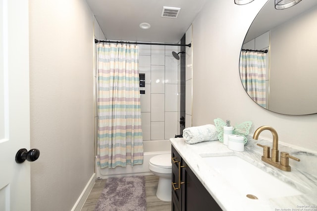 full bathroom with vanity, wood-type flooring, shower / bath combination with curtain, and toilet