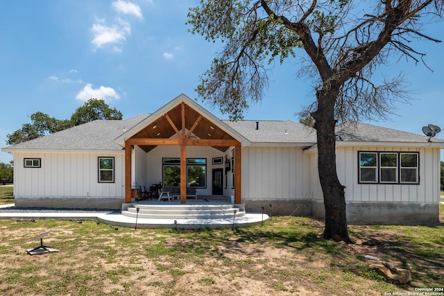 back of property with a lawn