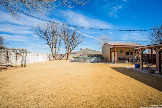 view of yard featuring a covered pool and a patio area