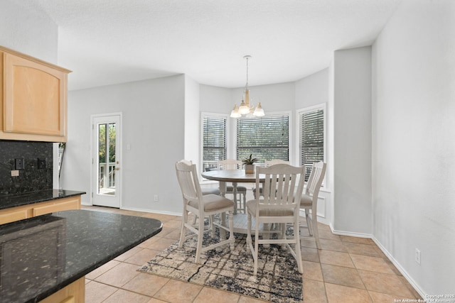 dining space featuring an inviting chandelier and light tile patterned flooring