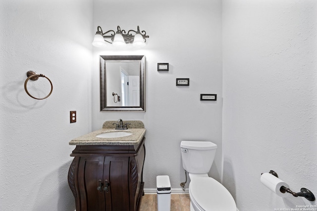 bathroom with vanity, hardwood / wood-style floors, and toilet