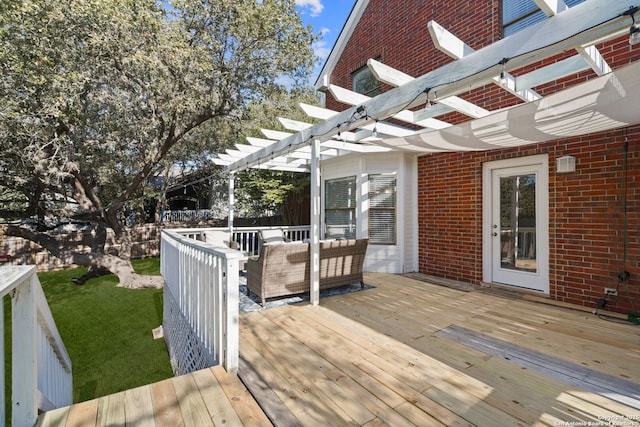 wooden terrace featuring a yard, outdoor lounge area, and a pergola