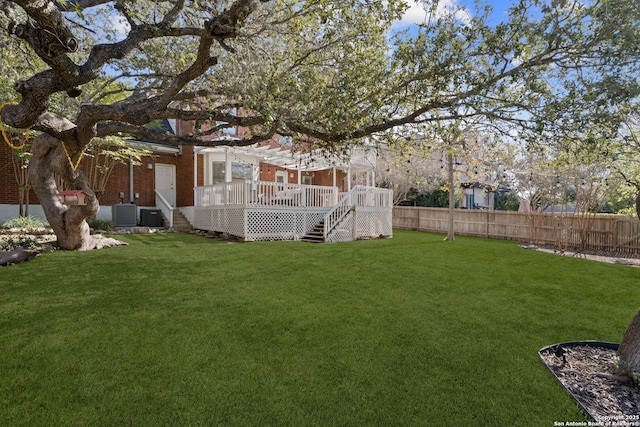 view of yard with central AC unit and a deck