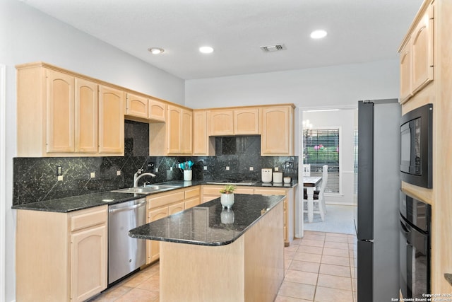 kitchen featuring light brown cabinetry, sink, a kitchen island, and black appliances