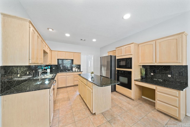 kitchen with a kitchen island, light brown cabinetry, tasteful backsplash, dark stone countertops, and black appliances