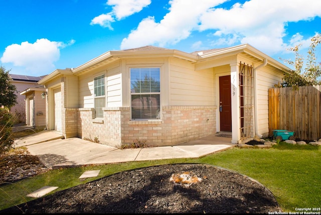 view of front of home with a garage and a front lawn