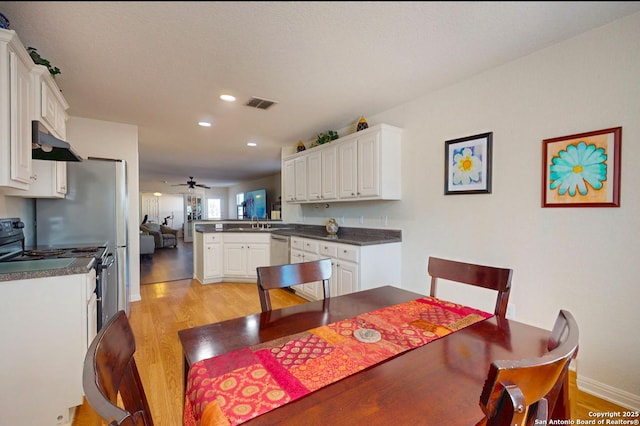 dining area with ceiling fan and light hardwood / wood-style flooring