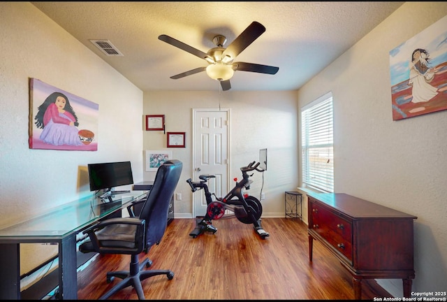 office area with ceiling fan, hardwood / wood-style floors, and a textured ceiling