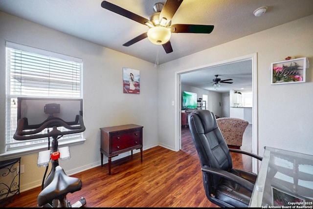 home office with plenty of natural light and dark hardwood / wood-style floors