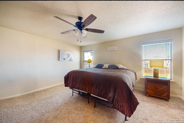 carpeted bedroom featuring a textured ceiling and ceiling fan