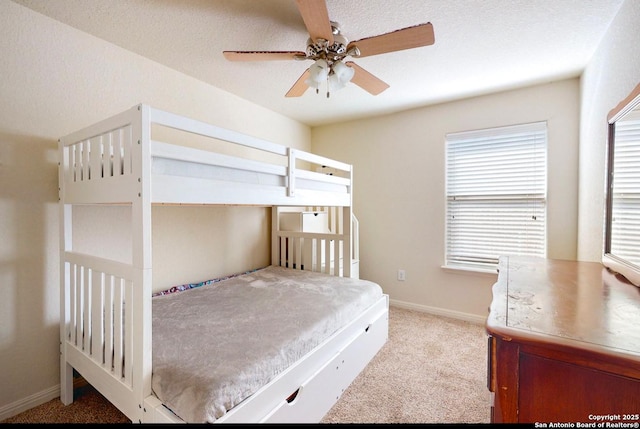 bedroom with light colored carpet, a textured ceiling, and ceiling fan