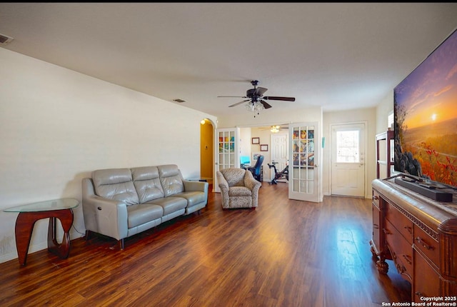 living room featuring dark wood-type flooring, ceiling fan, and french doors