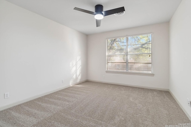 spare room featuring ceiling fan and carpet flooring