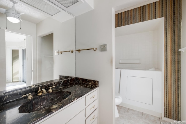 bathroom featuring tile patterned floors, toilet, and vanity