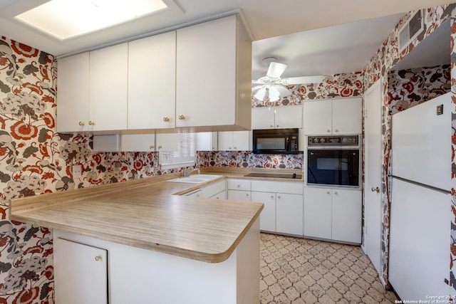 kitchen with sink, ceiling fan, black appliances, white cabinets, and kitchen peninsula