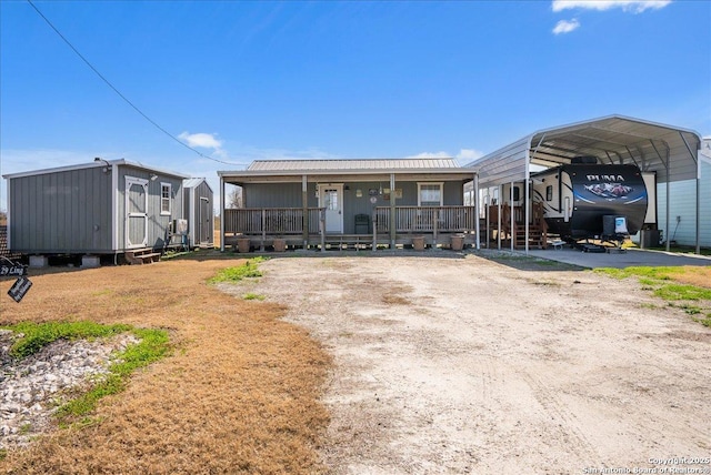 view of front of property featuring a porch and a carport