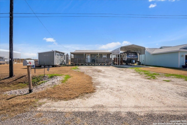 view of front of property featuring a carport and covered porch