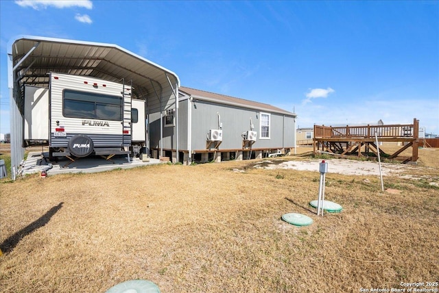 exterior space with a lawn and a carport