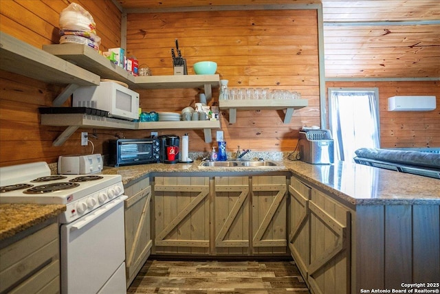 kitchen with dark wood-type flooring, sink, wooden walls, kitchen peninsula, and white appliances