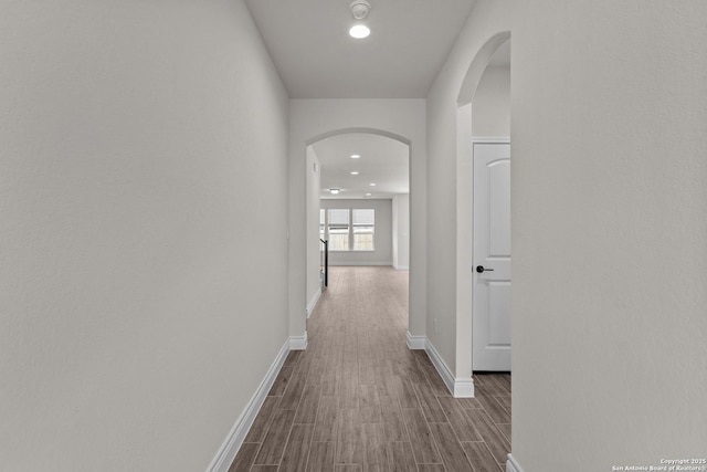 hallway with wood-type flooring