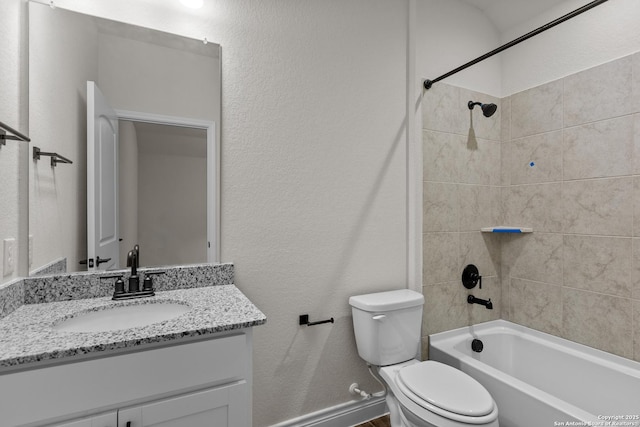 full bathroom featuring vanity, tiled shower / bath combo, and toilet