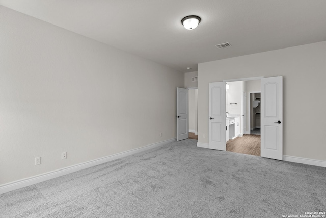 unfurnished bedroom with light carpet