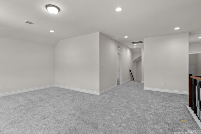 interior space featuring carpet flooring and vaulted ceiling