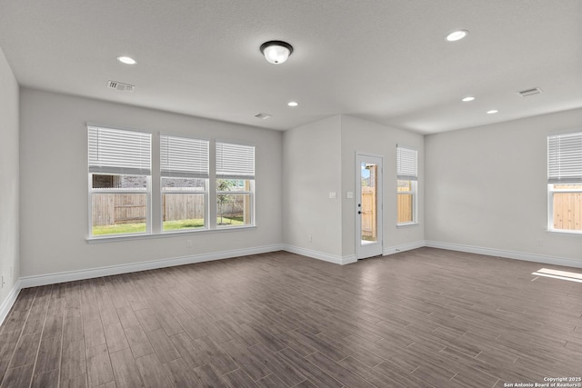 unfurnished room with dark hardwood / wood-style floors