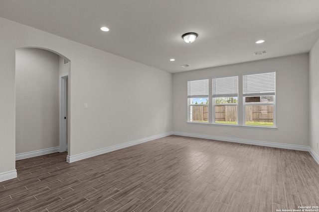 unfurnished room with dark wood-type flooring