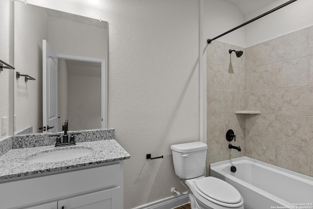 full bathroom featuring vanity, toilet, and tiled shower / bath combo