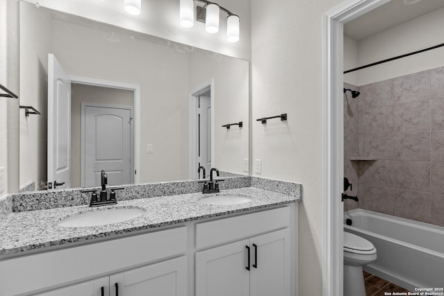 full bathroom with vanity, hardwood / wood-style flooring, toilet, and tiled shower / bath