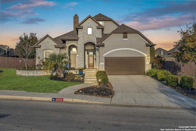 french country inspired facade with a garage and a lawn