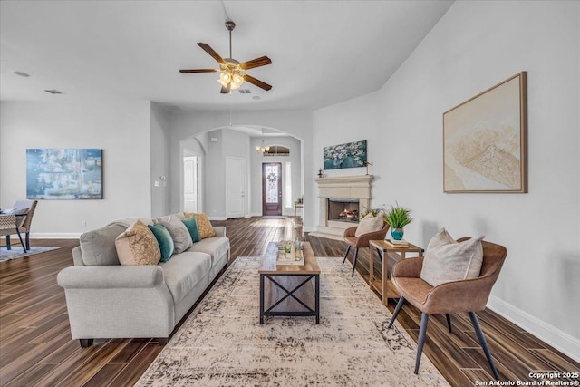 living room featuring dark hardwood / wood-style floors and ceiling fan