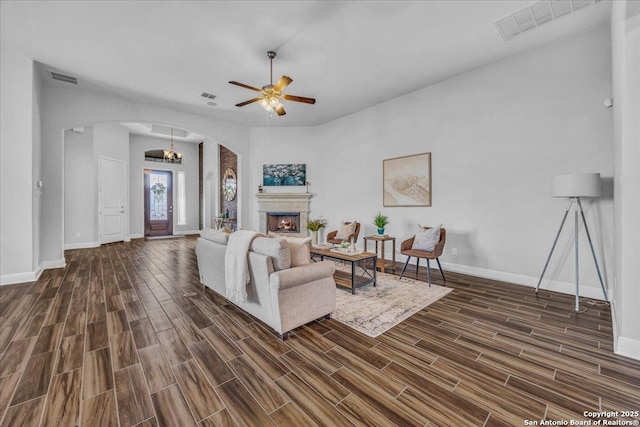 living room with ceiling fan with notable chandelier