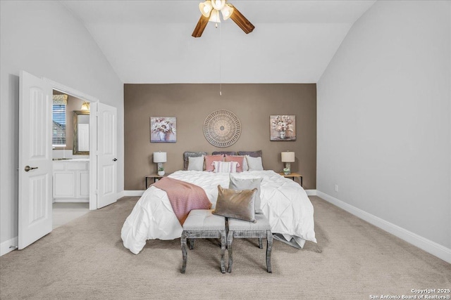 carpeted bedroom featuring vaulted ceiling, connected bathroom, and ceiling fan