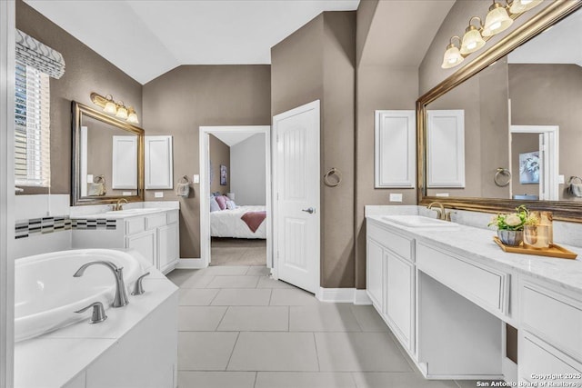 bathroom with tile patterned flooring, vanity, lofted ceiling, and tiled bath