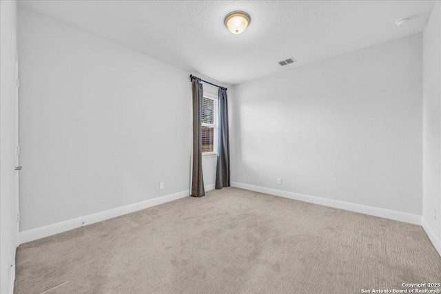 carpeted spare room featuring a textured ceiling